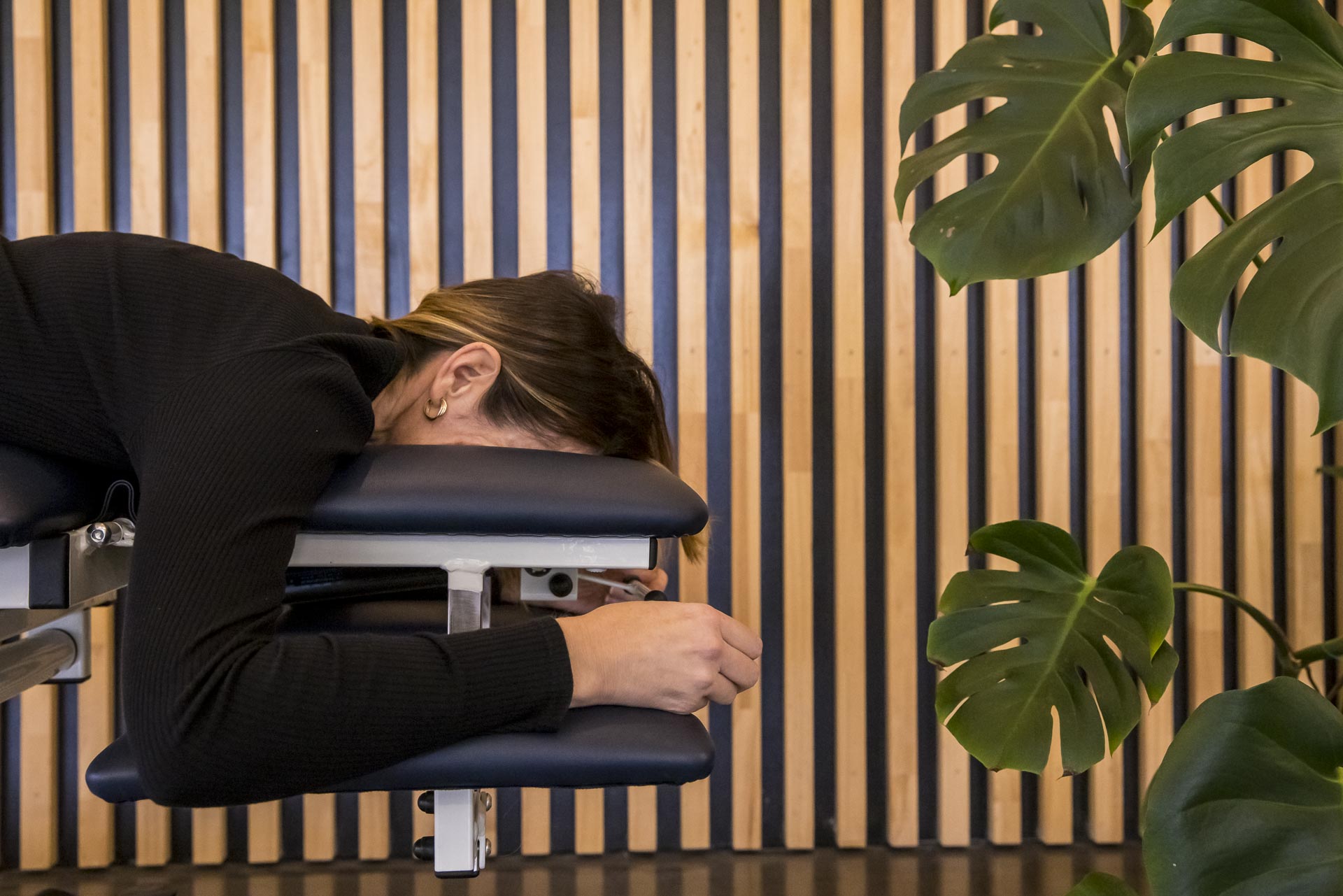 Someone resting face down on a treatment table at the All for One Kensington clinic